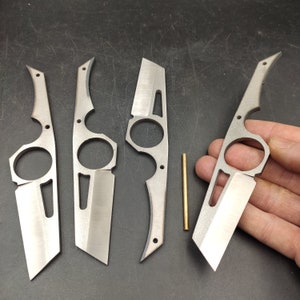 May include: Four silver metal pocket knives with a unique design. Each knife has a ring on the handle and a blade that folds into the handle.