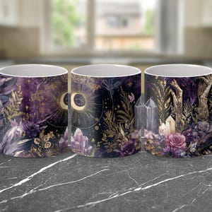 May include: Three white ceramic mugs with a celestial design. The mugs feature a dark purple background with gold accents, crystals, and floral elements. The design includes a crescent moon, sun, and eye.