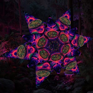 May include: A star-shaped, psychedelic art piece with a complex, repeating pattern. The design features a vibrant mix of purple, red, green, and yellow, creating a mesmerizing visual effect. The artwork is set against a dark, forested background.