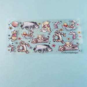 May include: A sheet of clear vinyl stickers featuring Winnie the Pooh and his friends. The stickers feature characters like Winnie the Pooh, Piglet, Tigger, Eeyore, and Rabbit. The stickers are perfect for adding a touch of whimsy to your planner, laptop, or water bottle.