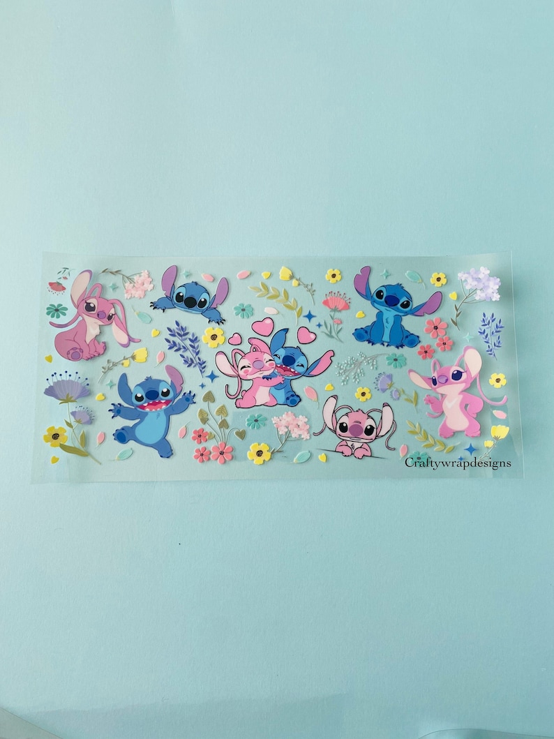May include: A sheet of clear vinyl stickers featuring various cartoon characters from the Disney movie Lilo & Stitch. The characters are blue, pink, and purple and are surrounded by flowers and leaves in shades of yellow, pink, and green. The text "Craftywrapdesigns" is printed in the bottom right corner.