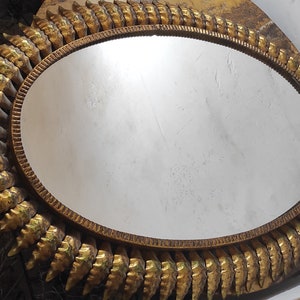 Large oval sun mirror made of gold tin plate