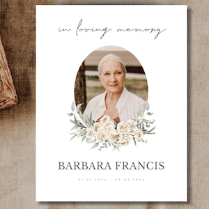 May include: In loving memory of Barbara Francis, a white framed memorial card with a photo of a woman and a floral wreath. The dates 01.01.1944 - 05.04.2022 are printed below the name.