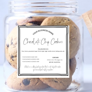 May include: A clear glass jar filled with chocolate chip cookies. The jar has a wooden lid and a white label with black text that reads "Chocolate Chip Cookies" and lists ingredients. The cookies are golden brown with visible chocolate chips.