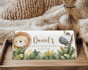 May include: A white chocolate bar wrapper with a lion and zebra illustration. The wrapper says "Daniel's First Birthday" with the date "MAR 30TH, 20XX".