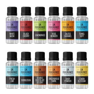 May include: Twelve clear glass bottles with black caps, each containing a different fragrance oil. The bottles are labelled with the text "UK Fragrance Supplies" and the name of the fragrance, such as "White Musk", "Black Cherry", "Lemongrass", "Rose Wonder", "Salted Caramel", "Towel Soft", "Fresh Lnr", "Bubblegum", "Double Chocolate Delight", "Gingerbread Swirl", "Baby Powder", and "Lemon Blossom".