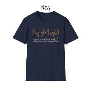 May include: Navy blue t-shirt with the word "NOMAD" in gold lettering. The shirt also features the text "Some souls are simply born to go collecting stories, moments, learnings and miles."