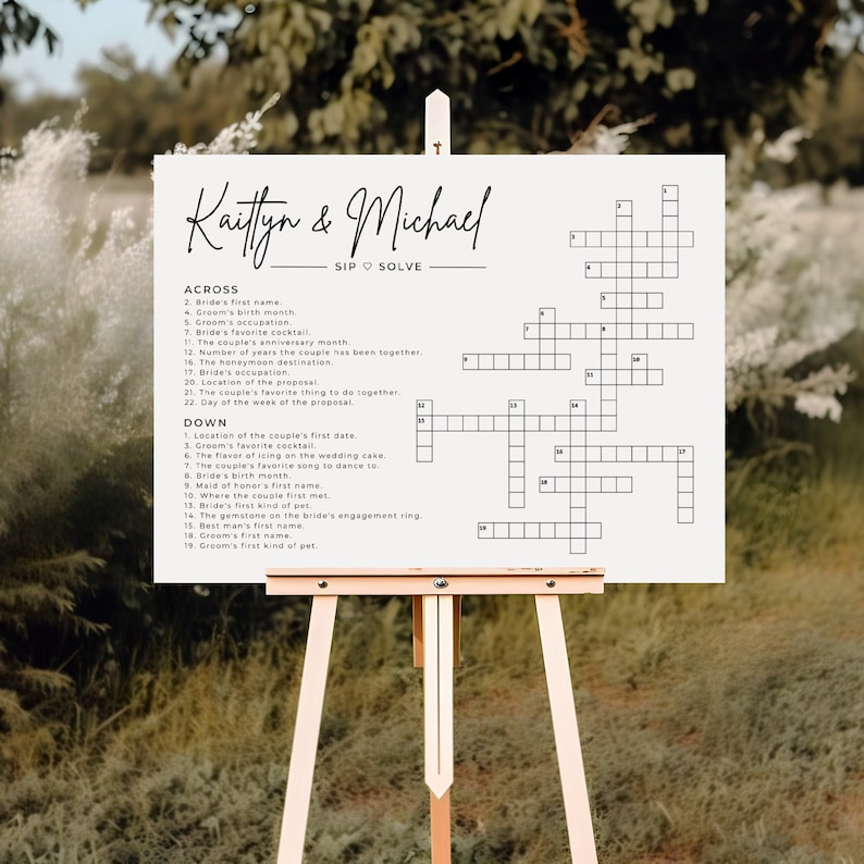 May include: A white wedding crossword puzzle with the names Kaitlyn & Michael at the top. The crossword puzzle is on a wooden easel. The puzzle is a fun way for guests to learn more about the couple.