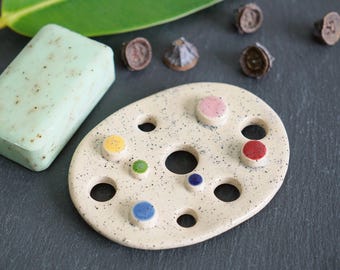 Ceramic soap dish with colorful dots and drainage holes, glossy glazed with black speckles, handmade