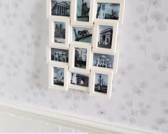 May include: White miniature picture frame with 12 individual frames, each with a black and white photo of a famous landmark. The frame is mounted on a white wall with a floral pattern.