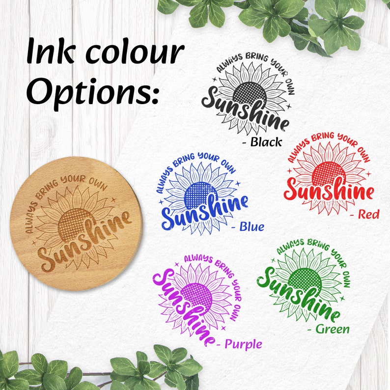 May include: Four wooden coasters featuring a sunflower design and the text "Always bring your own sunshine" in various colours: black, blue, red, and purple.