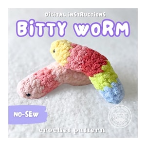 May include: Digital instructions for a Bitty Worm no-sew crochet pattern. The image displays two plush, textured worms made of yarn. One worm features a gradient of yellow, red, lime green, and blue. The other is a soft pink and light peach color.