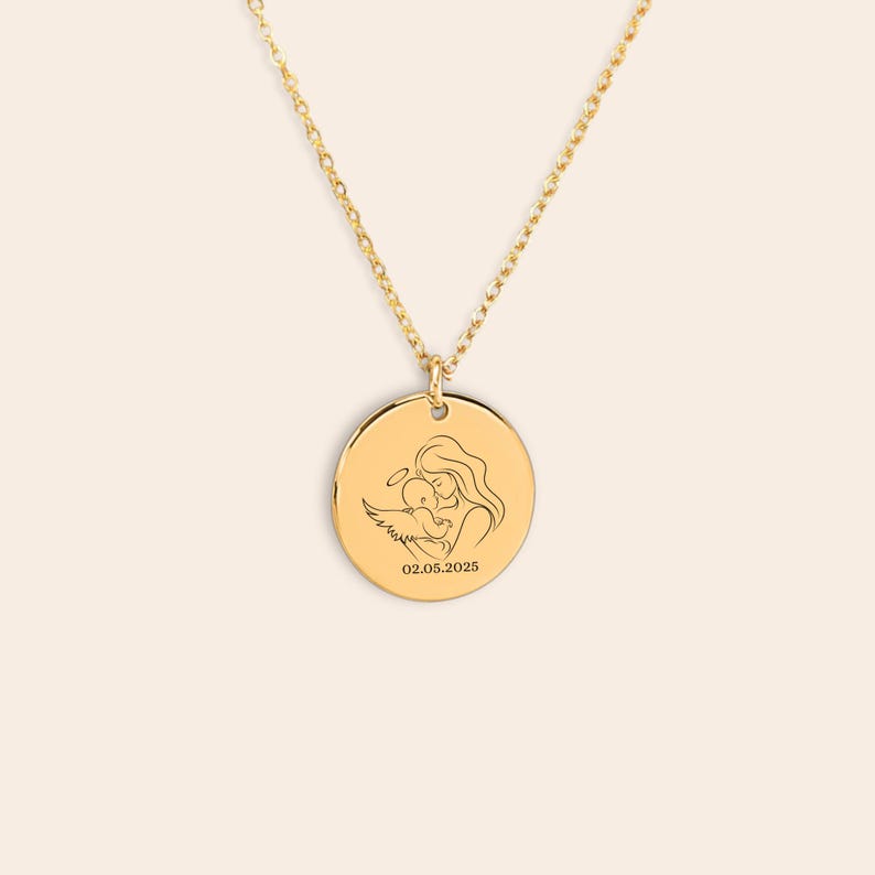 A mother embracing a baby angel. The date satamped on the bottom of the pendant.
