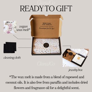 May include: A gift box set containing a vegan wax melt, a cleaning cloth, and a jewelry box. The wax melt is made from a blend of rapeseed and coconut oils, is free from paraffin, and includes dried flowers and fragrance oil. The box is decorated with the text "More than just jewelry. It's an eternal memory. Personalized just for you!" and "Clara Co."