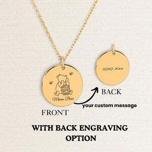 May include: Gold necklace with a round pendant featuring a line drawing of Winnie the Pooh holding a honey pot. The back of the pendant is blank and can be engraved with a custom message.  The text "XOXO Alex" is engraved on the back of the pendant in the image.