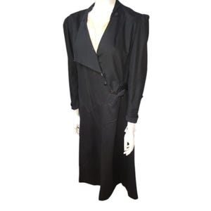 May include: A long black wrap dress with a V-neckline and a tie at the waist.