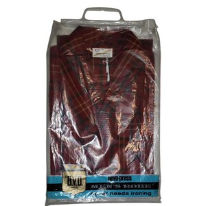 May include: A red and black plaid robe in a plastic bag with a blue label that reads "B.V.D. Brand, novo-press, Men's Robe, Never needs ironing."