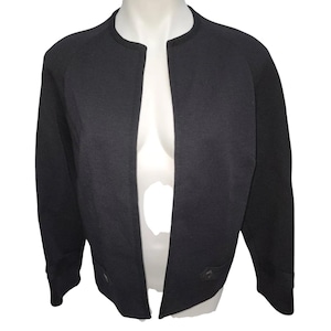 May include: A black open-front cardigan with long sleeves and a slightly cropped length.