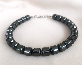 May include: A black hematite beaded bracelet with a silver clasp.