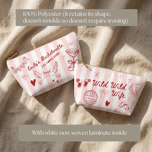 May include: Two pink and white striped cosmetic bags with gold zippers. One bag says "Emily's Bachelorette Los Cabos 2026" and features a martini glass and doves. The other says "Wild Wild Wife" with a disco ball and cowboy boots.