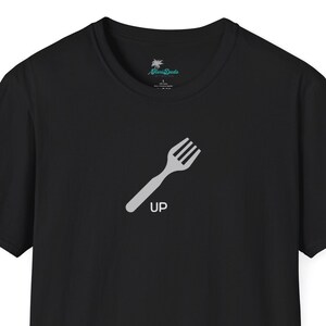 May include: Black short-sleeved t-shirt with a white fork graphic and the word "UP" printed below it.