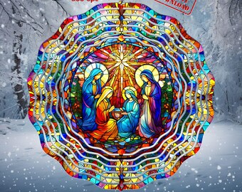 May include: A colorful stained glass wind spinner featuring a depiction of the nativity scene. The spinner has a circular design with multiple layers of glass, creating a kaleidoscope effect. The scene includes Mary, Joseph, and the baby Jesus, along with a star and other religious symbols.