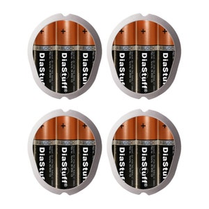 May include: Four brown AA batteries with the brand name "DiaStuff" printed on them. The batteries are arranged in a circle and are surrounded by a silver ring.
