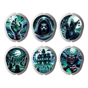 May include: Six round, silver-coloured coasters with different Halloween-themed illustrations. The coasters feature a zombie hand, a hooded figure, a ghost rider, a haunted house, a graveyard, and a werewolf.