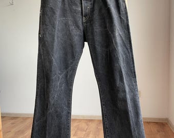 Vaqueros desgastados negros de corte acampanado de Neil Barrett, talla 38