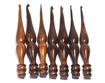 May include: Set of eight wooden crochet hooks with dark brown wood grain. The hooks are all the same size and have a smooth, polished finish.