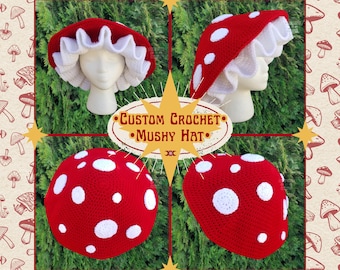 May include: A custom crochet mushroom hat in red with white polka dots and a white ruffled brim. The hat is displayed on a mannequin head. The image includes the text "Custom Crochet Mushy Hat".