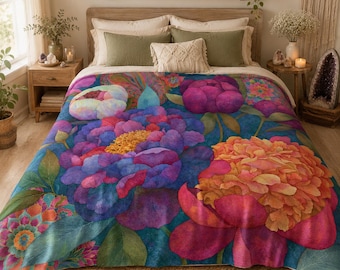 May include: A plush bed blanket featuring a vibrant, large-scale floral pattern with deep purple, magenta, and orange blossoms set against a dark blue background. The design includes detailed green leaves and intricate petal textures throughout.