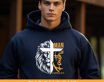 May include: Navy blue hoodie featuring a white cross with a lion's face and the words "Man of Faith." The design includes the Bible verse "I Corinthians 16:13" in a yellow font. The bottom of the image displays "SVG PNG DXF 300 DPI."