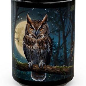 May include: Black ceramic mug with a colorful image of an owl perched on a branch in a moonlit forest. The owl has brown and white feathers and yellow eyes.