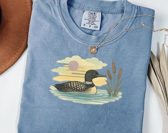 Loon Bird Shirt | Lake Sunset Tee with Cattails | Nature Lover Graphic Top | 90s Style Clip Art Design | Retro Loon Bird Graphic Tee