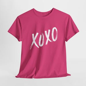 a pink t - shirt with the word xoxo printed on it