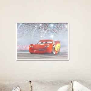 May include: A red race car with a yellow lightning bolt design on the side, driving on a race track with a crowd of people in the background. The car has a smiling face and is looking directly at the viewer.