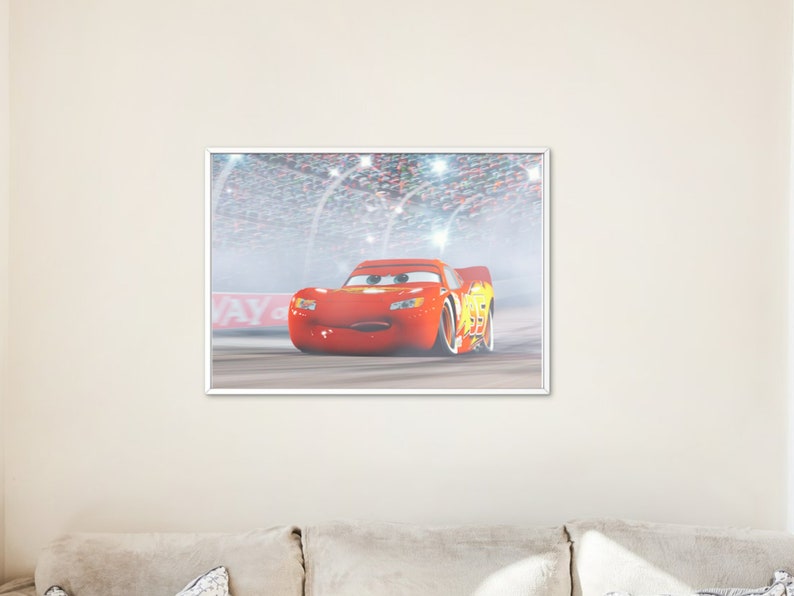 May include: A red race car with a yellow lightning bolt design on the side, driving on a race track with a crowd of people in the background. The car has a smiling face and is looking directly at the viewer.