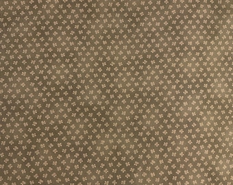 May include: A brown fabric with a repeating pattern of small, light brown floral designs.