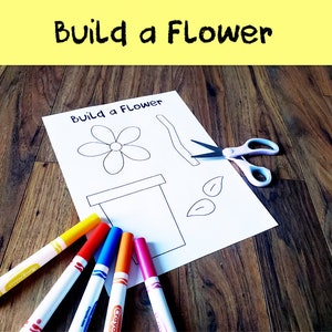 May include: A printable craft activity for kids to build a flower. The printable includes a flower, stem, leaves, and pot. The image shows the printable, scissors, and colored markers.