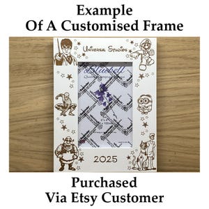 May include: White customized photo frame with engraved cartoon characters, stars, and the text "2025." The frame includes characters like Harry Potter, Spider-Man, and a Minion. The text "Example Of A Customised Frame" is at the top.