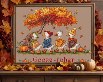 May include: A framed cross-stitch featuring four geese in autumn attire walking under a tree with falling leaves. The artwork is surrounded by fall foliage and pumpkins, with the word "Goose-tober" at the bottom.