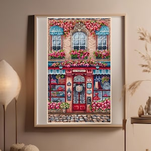 Può includere: Un dipinto di una vetrina con una porta rossa e finestre decorate con fiori. Il cartello sopra la porta recita "La Boutique".