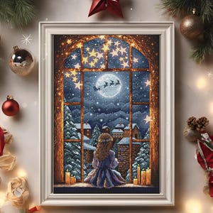 May include: A framed cross-stitch artwork depicting a girl looking out a window at a snowy winter scene. The moon is full and Santa's sleigh is flying in the sky with reindeer. The window is decorated with twinkling lights and candles.