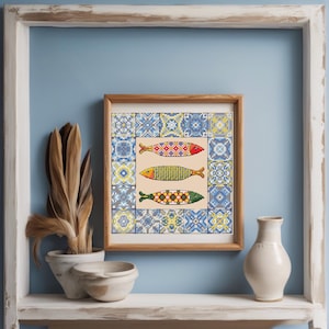 May include: A framed picture showing three decorative fish with detailed patterns, set against a backdrop of blue and white tile designs. The artwork is displayed on a shelf with decorative items.