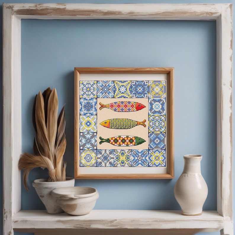 May include: A framed picture showing three decorative fish with detailed patterns, set against a backdrop of blue and white tile designs. The artwork is displayed on a shelf with decorative items.