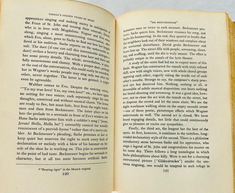 May include: A page from a book about the history of music in Vienna, featuring a black and white image of a page of text. The text discusses the opera "Die Meistersinger" by Richard Wagner, and the performance of the opera in Vienna. The text includes the words "The Feast of St. John", "Magdalena", "Pogner", "Eva", "Sachs", "Beckmesser", "Walther", "Jerum! Holla, Holla ho!" and "Gl&uuml;hw&uuml;rmchen".