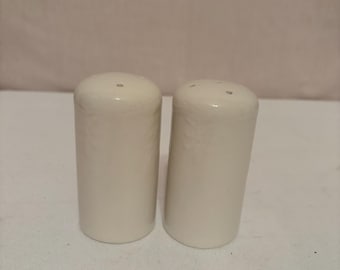 Set of off-white ceramic salt and pepper shakers. 