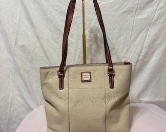 Dooney & Bourke Pebble Grain Small Lexington tote bag in white leather with brown trim.