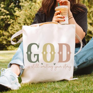 God Is Still Writing Your Story Tote Bag, Christian Canvas Bag for Women, Faith Encouragement Tote, Inspirational Gift for Her